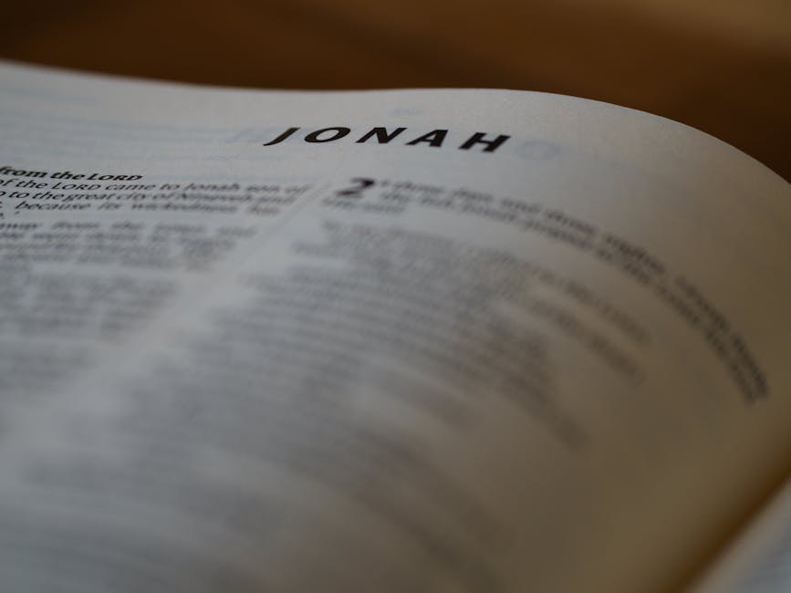 A close focus view of the Book of Jonah text from the Bible with a blurred background.