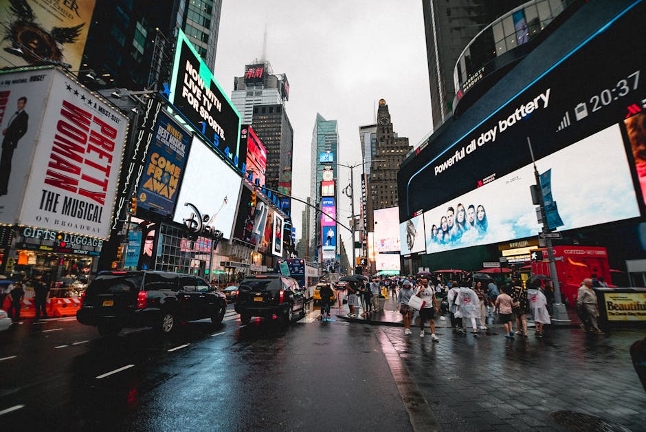 Vista noturna da Times Square em Nova York com letreiros luminosos e multidão animada.