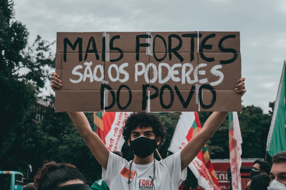 Manifestante segura cartaz com frase sobre o poder do povo em protesto pelo gás.